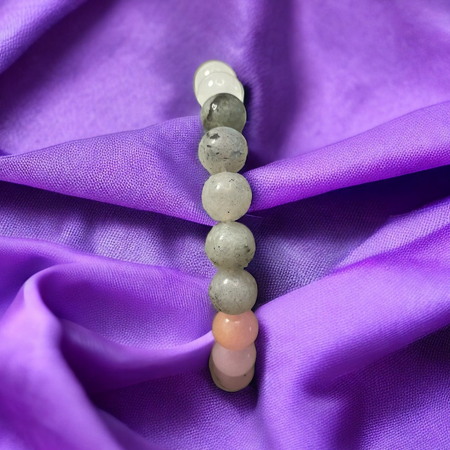 Entdecke unser vielseitiges Armband aus edlen und energiespendenden Steinen wie Rosenquarz, Rhodonit, Mondstein und Erdbeerquarz. Jeder Stein kann seine einzigartigen heilenden Eigenschaften mit sich bringen: Rosenquarz für Liebe und Harmonie, Rhodonit für emotionale Ausgeglichenheit, Mondstein für Intuition und Erdbeerquarz für ein Gefühl von Frieden und Herzöffnung. Trage diese wunderschöne Kombination an Deinem Handgelenk und spüre die positive Energie dieser kraftvollen Edelsteine den ganzen Tag über.